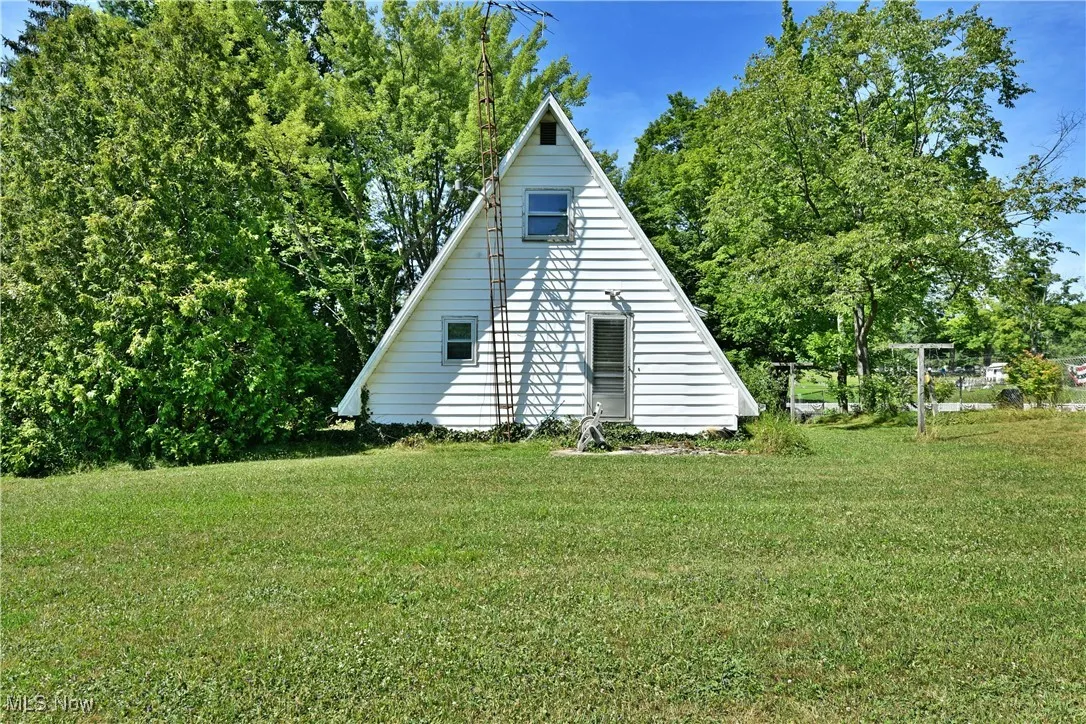 View of home's exterior with a yard