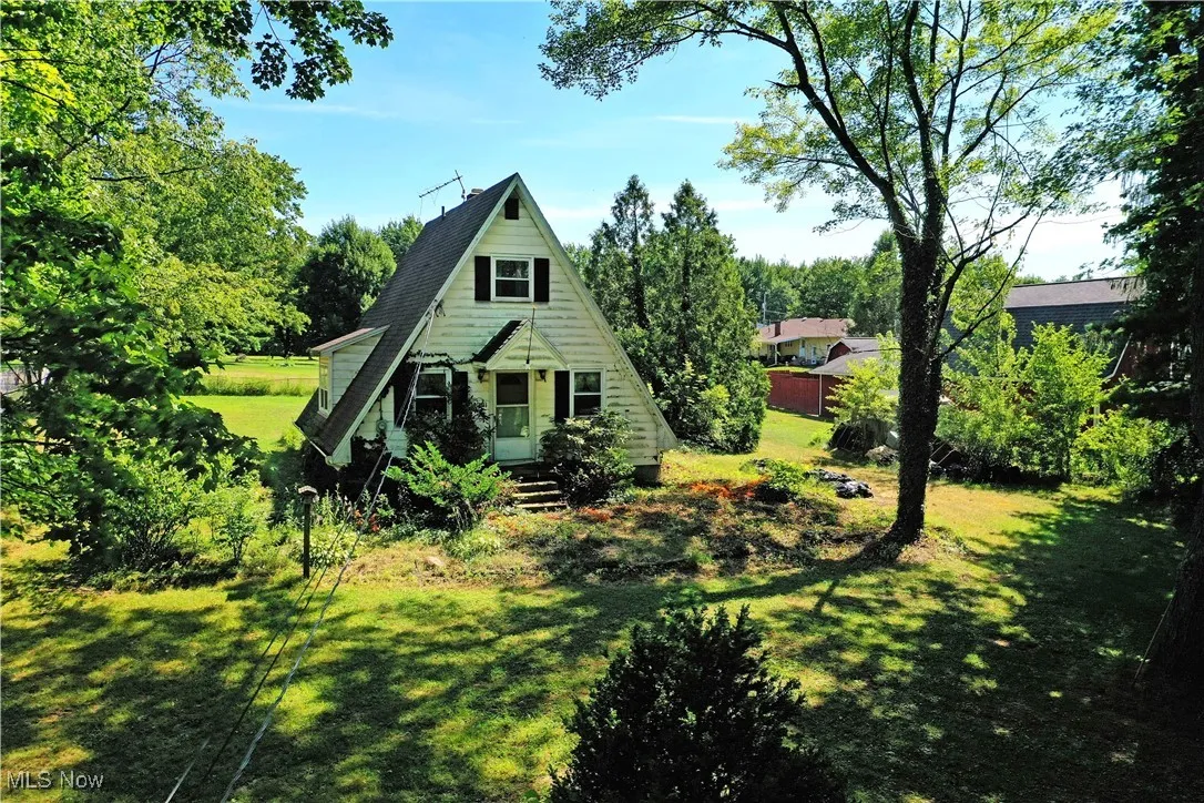 A-frame home with a front yard