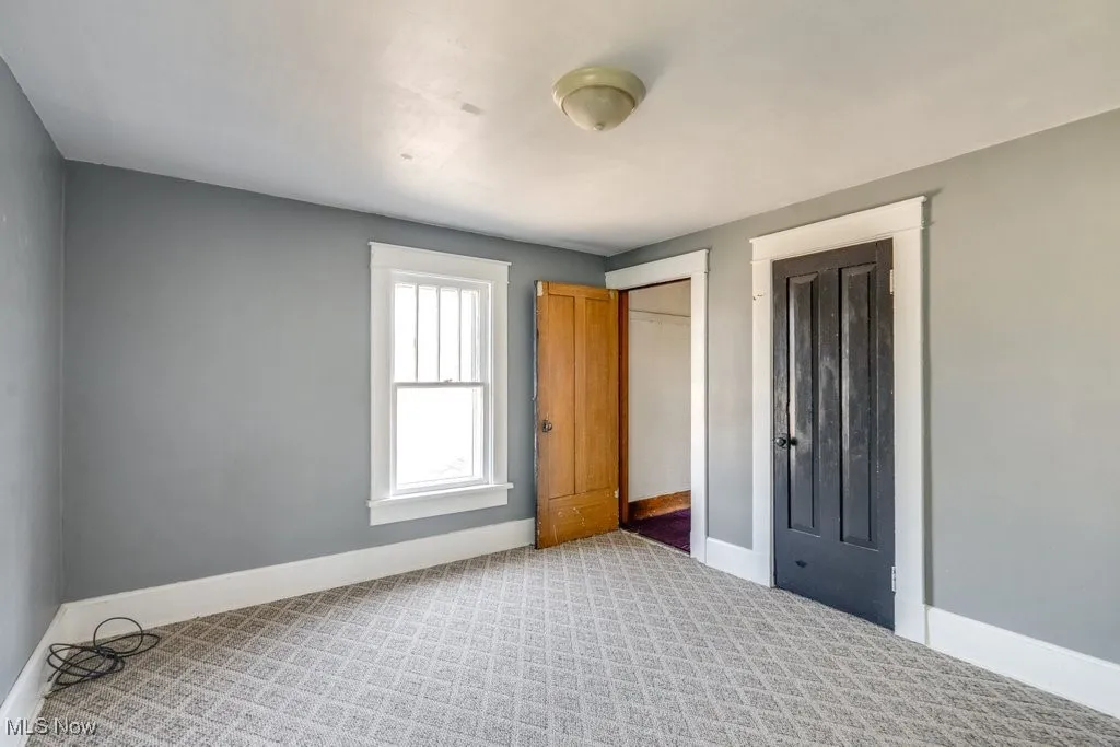 Unfurnished bedroom featuring baseboards and carpet floors