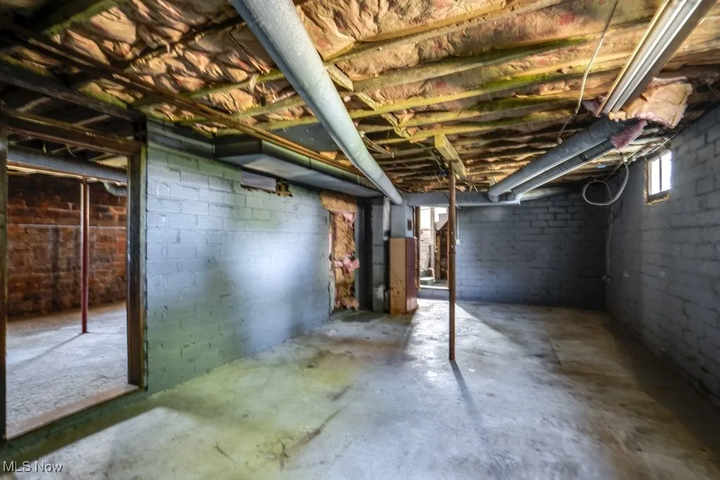 Below grade area featuring heating unit and plenty of natural light