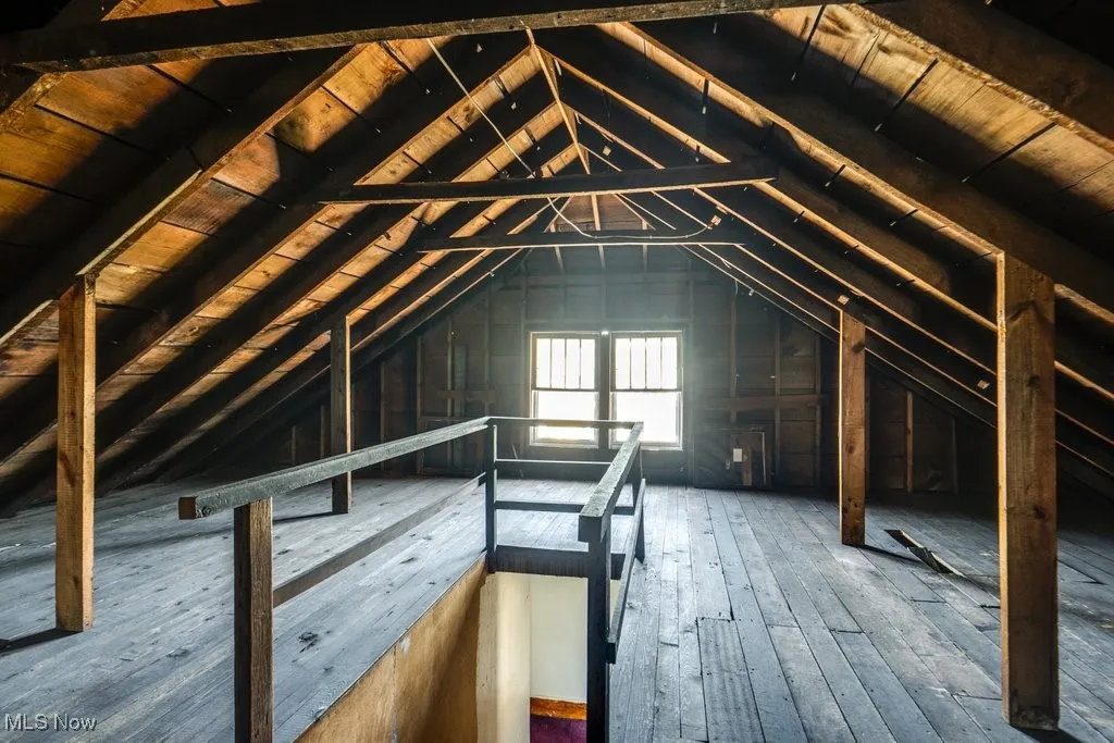 Unfinished attic with an upstairs landing