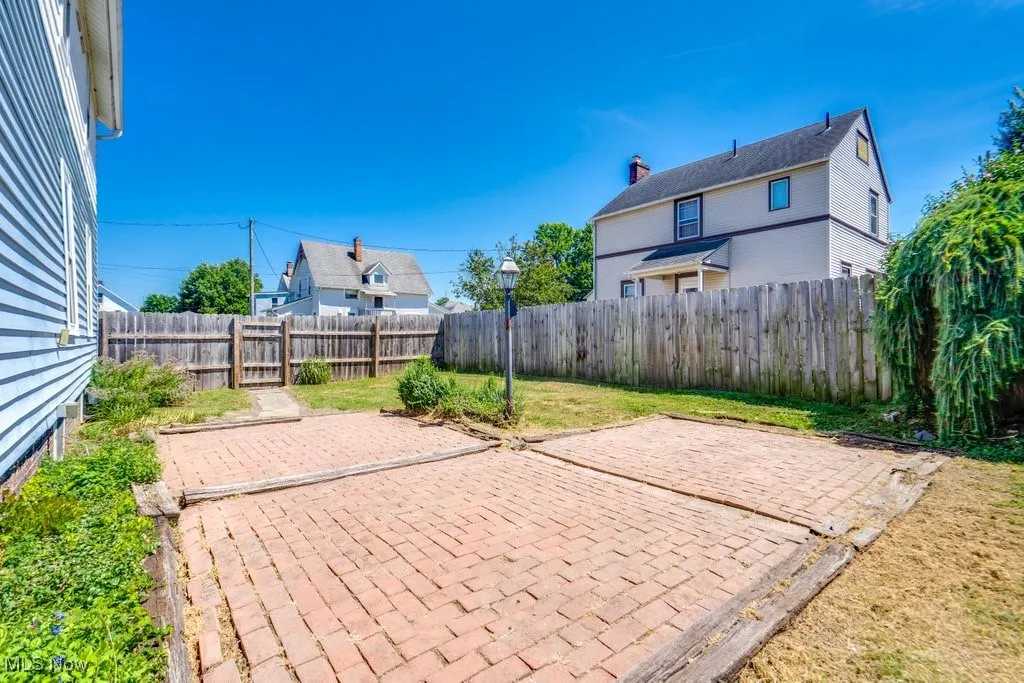 Fenced backyard with a patio
