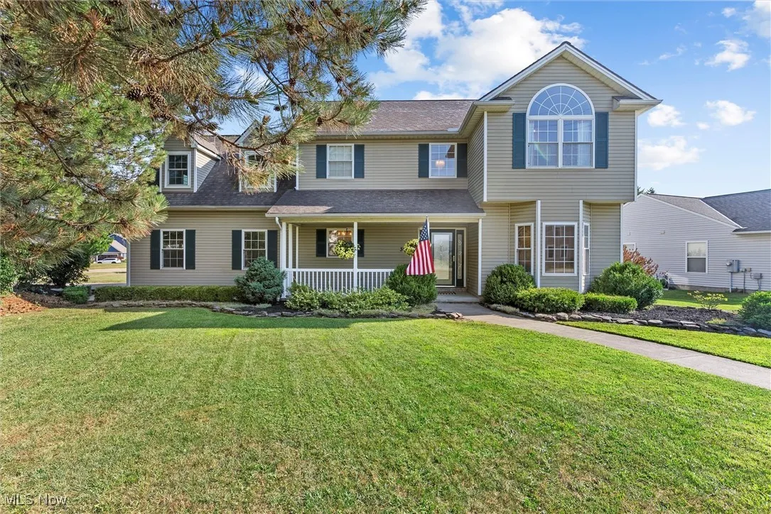 View of front of house with a porch and a front lawn