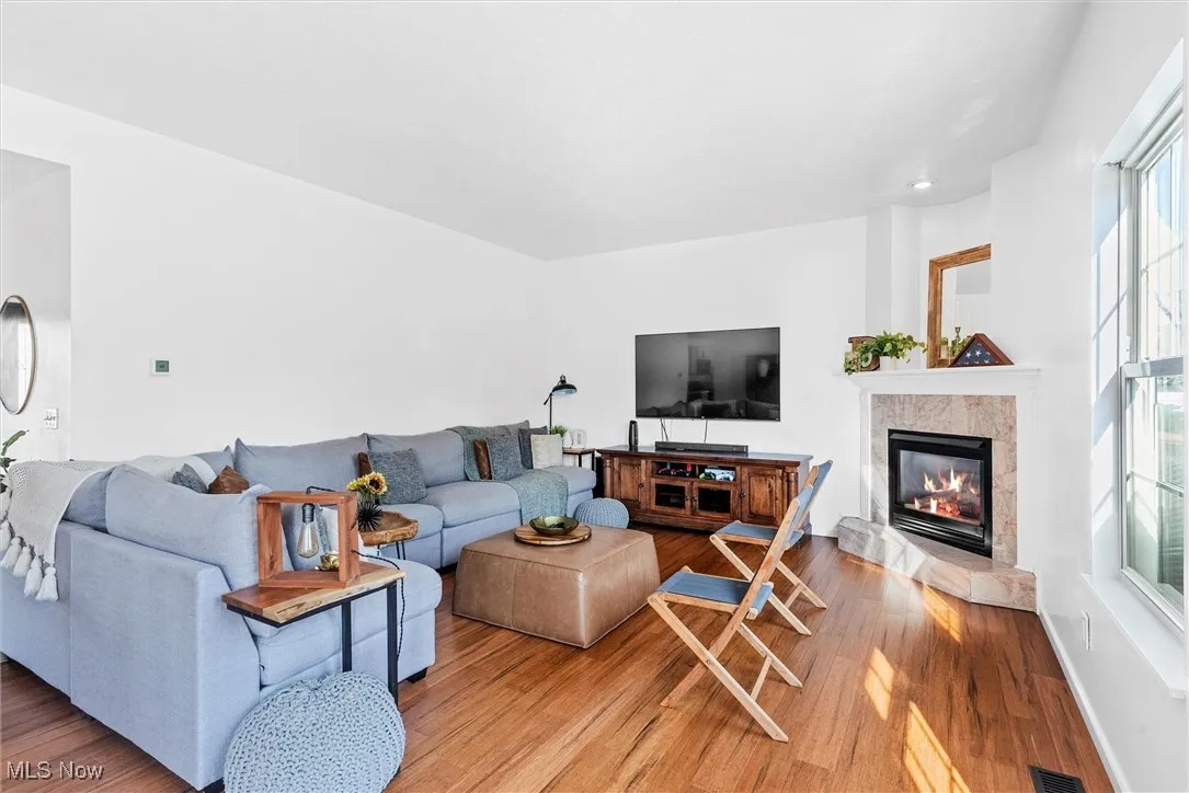 Living room featuring wood finished floors and a tile fireplace