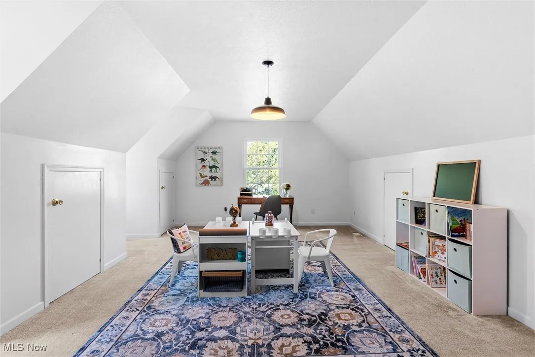 Office featuring lofted ceiling and carpet floors