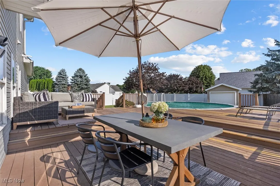 Deck with an outdoor hangout area and an outbuilding