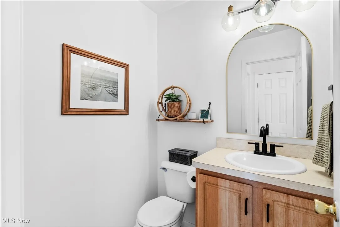 Half bathroom featuring toilet and vanity