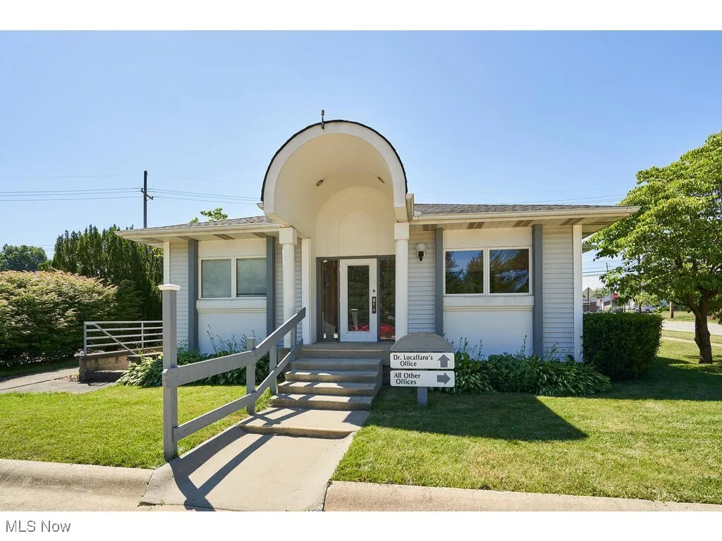 View of front facade featuring a front yard and french doors