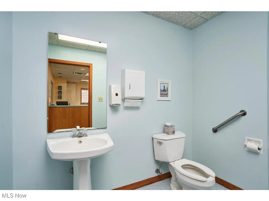 Bathroom featuring toilet and a drop ceiling