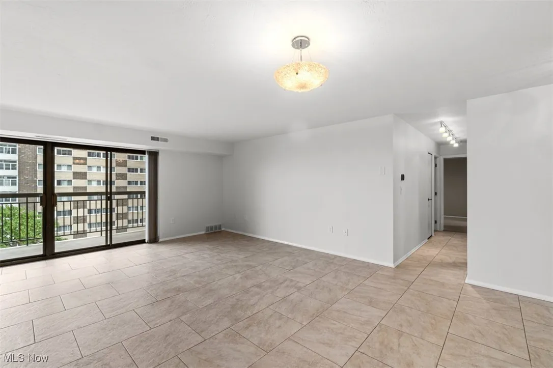 Spare room with baseboards and light tile patterned floors