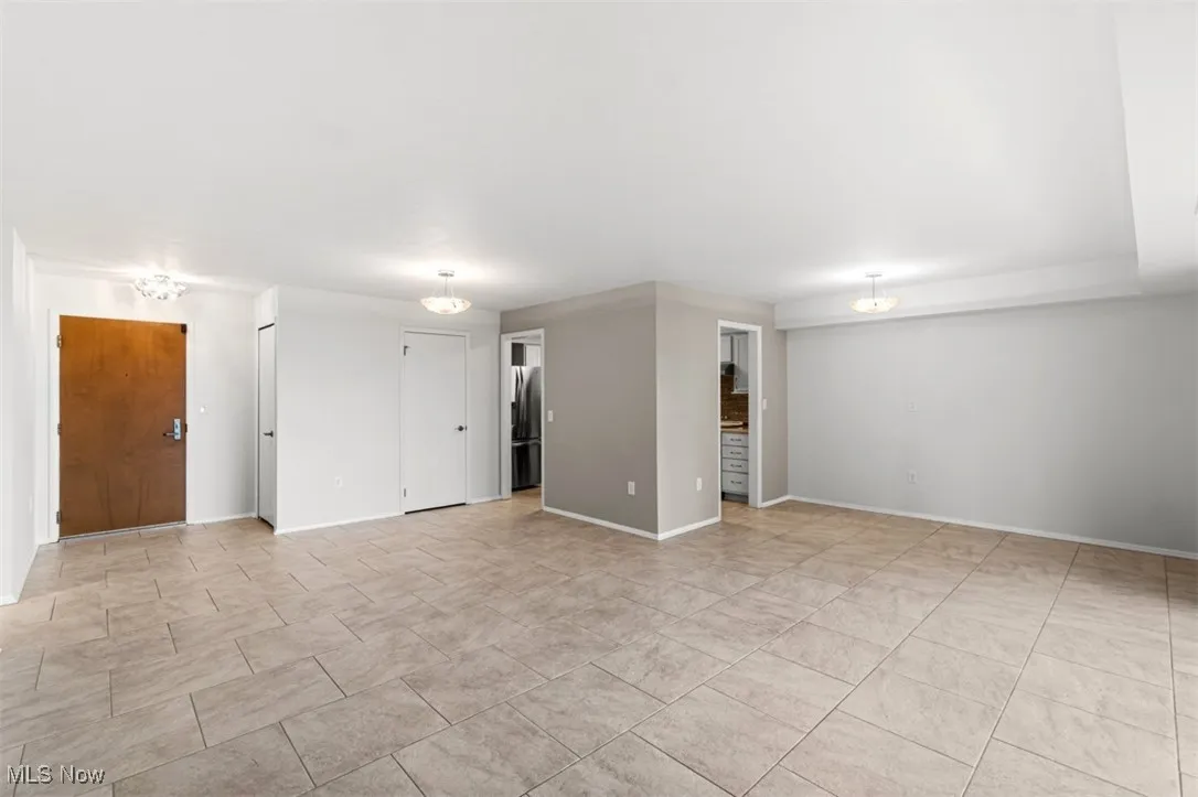 Unfurnished room featuring baseboards and light tile patterned flooring