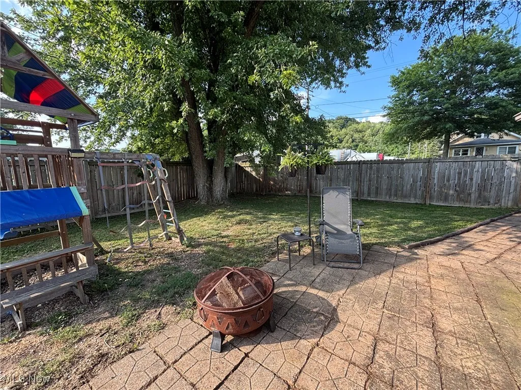 View of fenced in yard area with patio