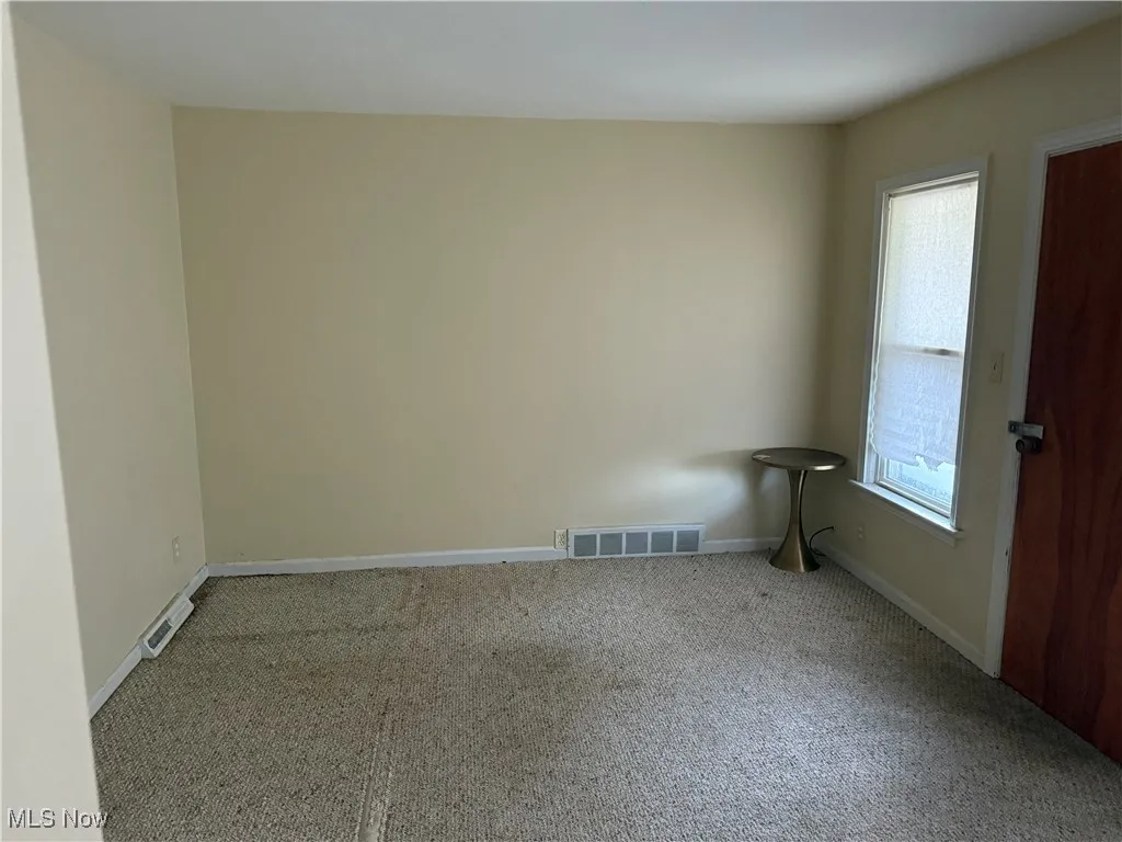 Spare room with carpet floors and baseboards
