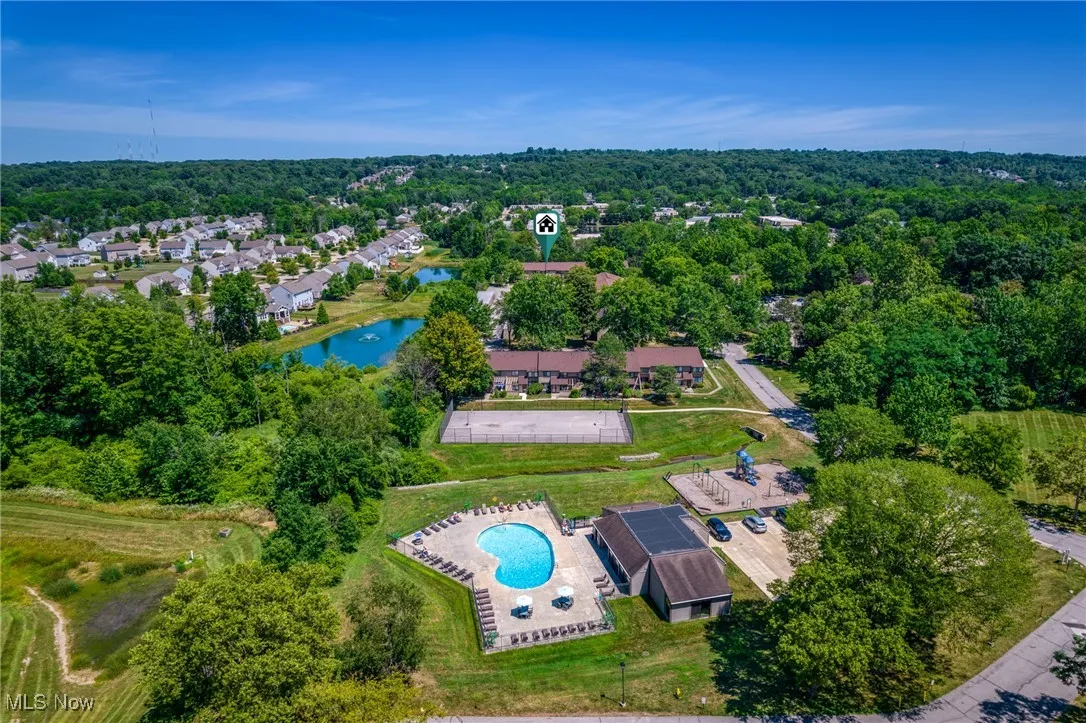 Bird's eye view of a pool area and a large body of water