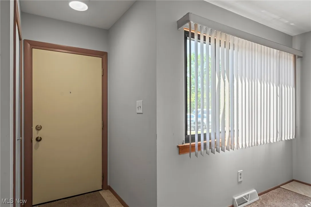 Doorway to outside with baseboards
