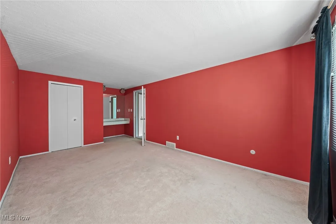 Unfurnished bedroom with carpet floors