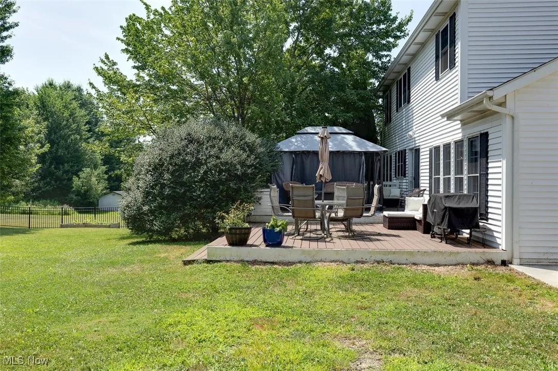 View of yard featuring a deck and a gazebo