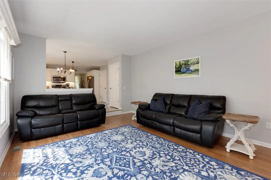 Living area with a chandelier and wood finished floors