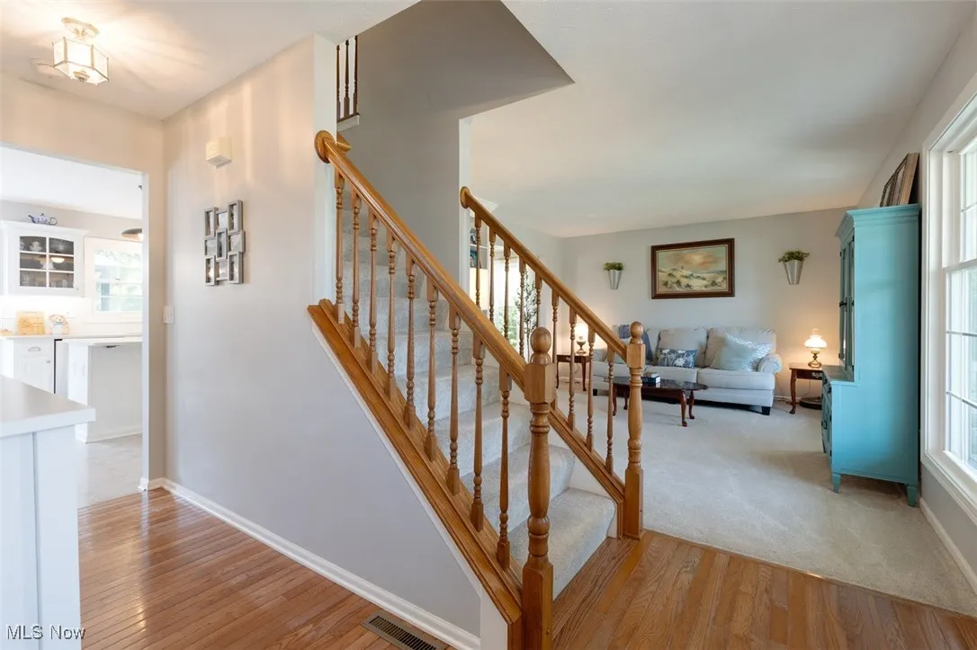 Stairs featuring hardwood / wood-style flooring and baseboards