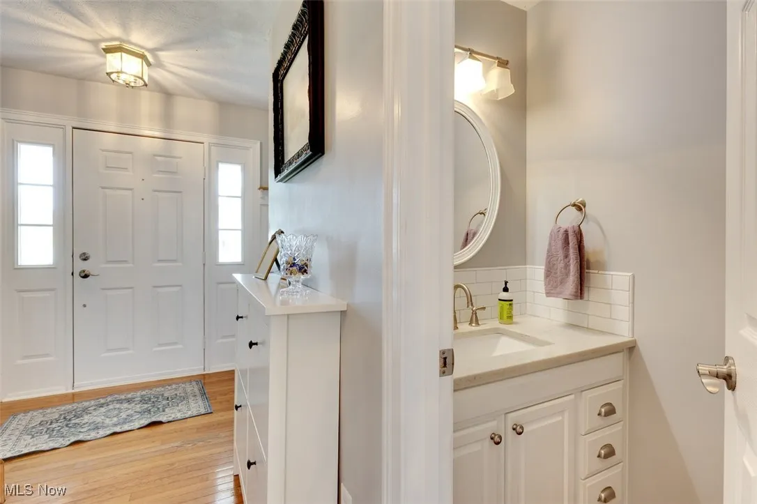 Foyer entrance with light wood-style flooring