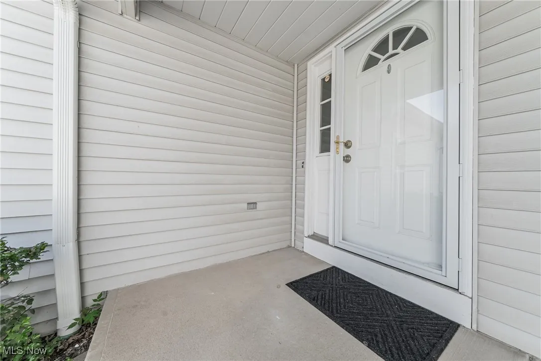 View of exterior entry with covered porch