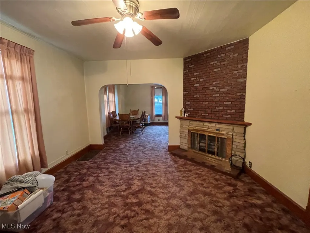 with fireplace and archway to the dining area.