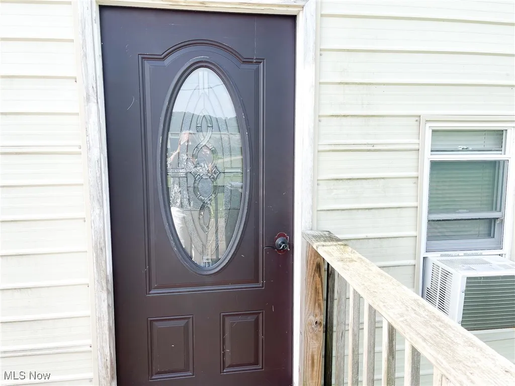Property entrance featuring cooling unit