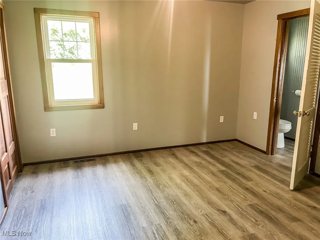 Unfurnished bedroom featuring wood finished floors