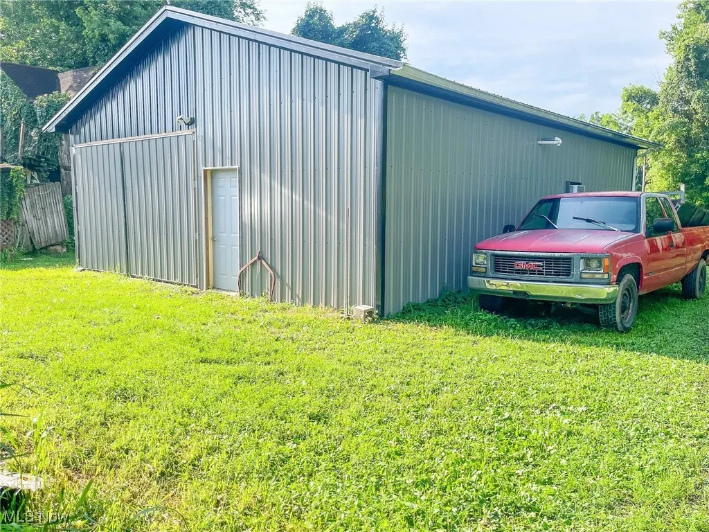View of pole building featuring a lawn