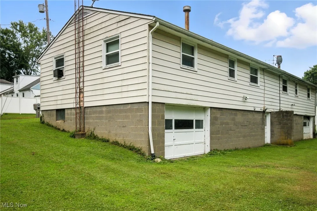 Rear view of property with an attached garage
