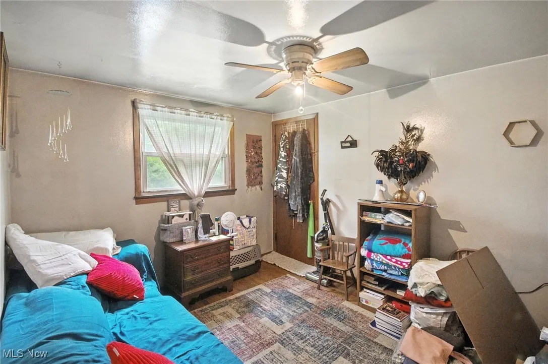 Bedroom with ceiling fan and wood finished floors