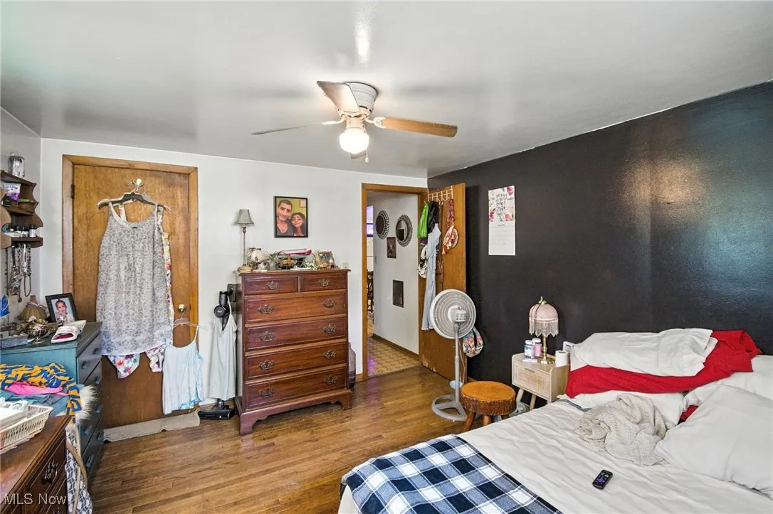 Bedroom with wood finished floors and a ceiling fan