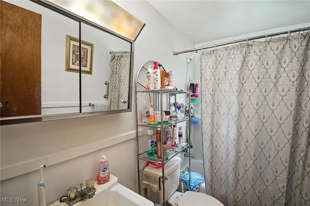 Bathroom featuring shower / bath combo and a sink