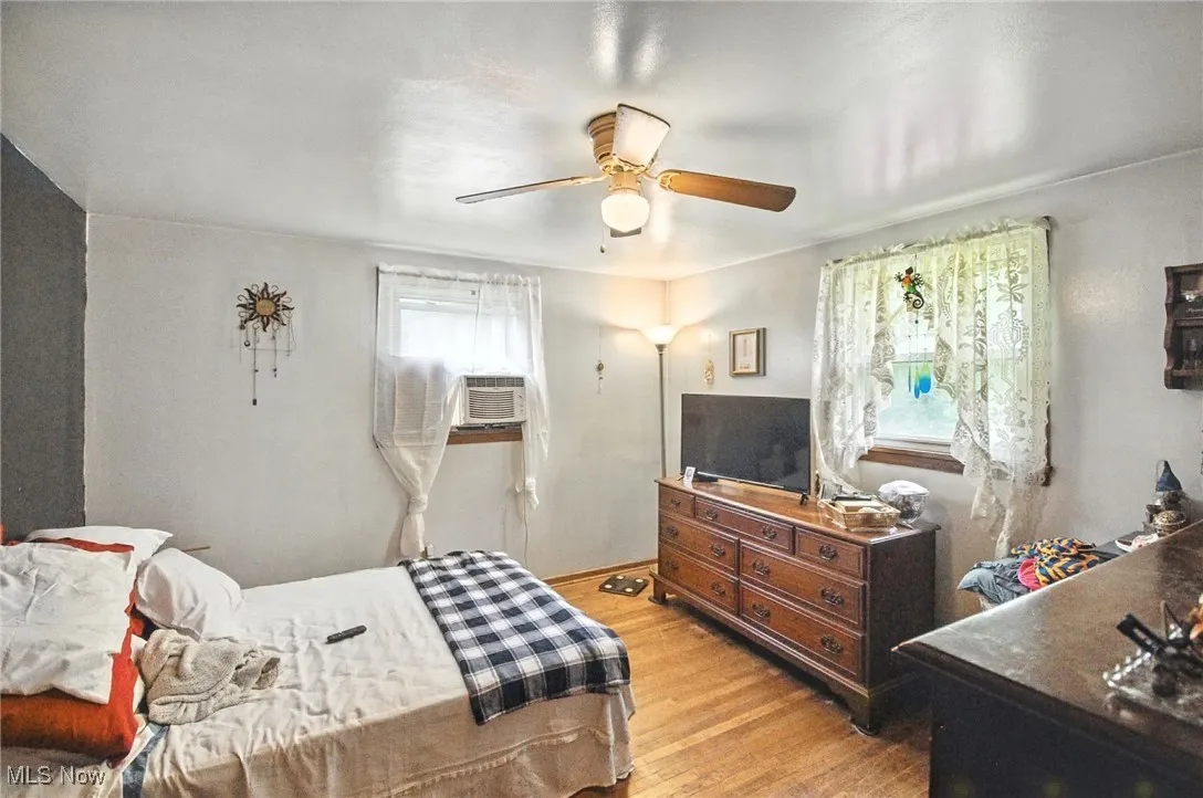 Bedroom with light wood-style floors and ceiling fan