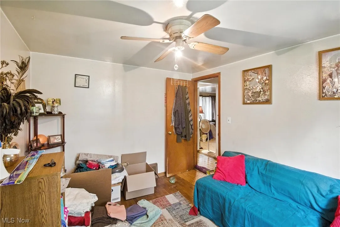 Living room with ceiling fan and wood finished floors