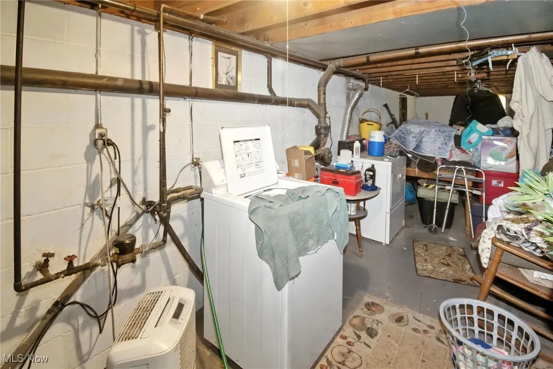Unfinished basement featuring separate washer and dryer
