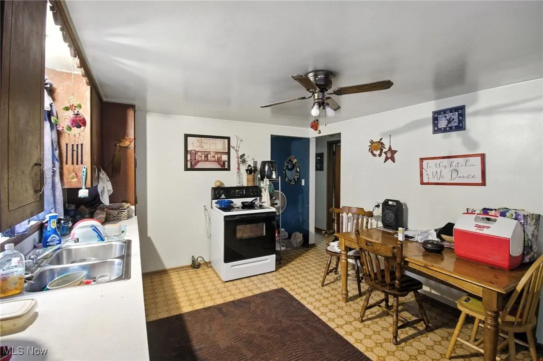 Office with a ceiling fan and a sink