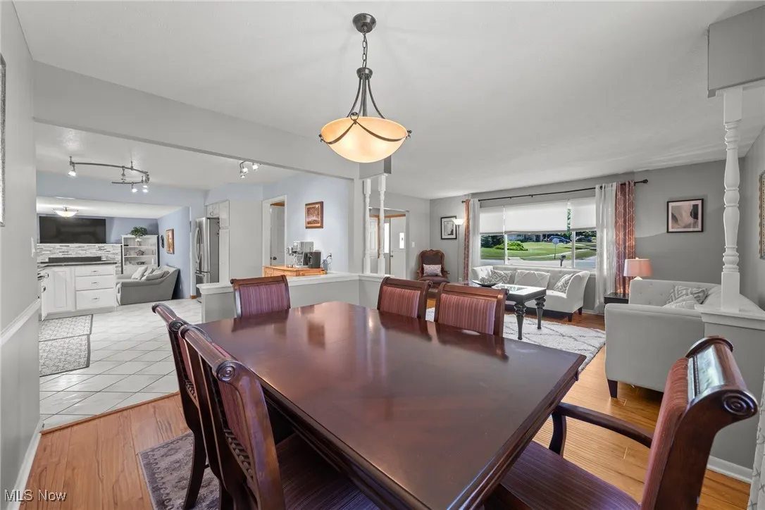 Dining space featuring light wood-style floors and rail lighting