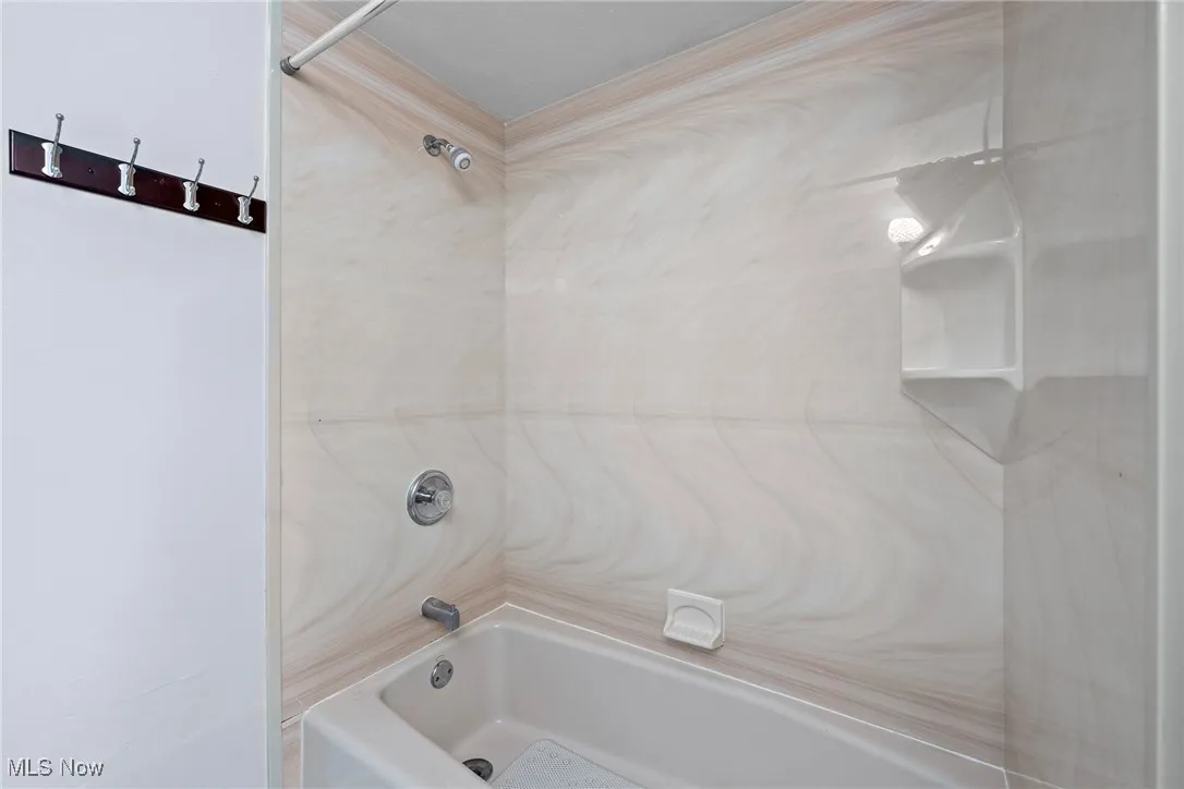 Full bath featuring shower / bath combination
