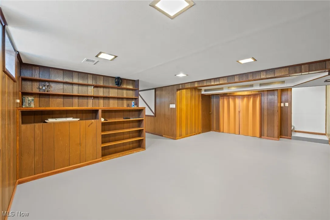 Finished below grade area featuring wood walls