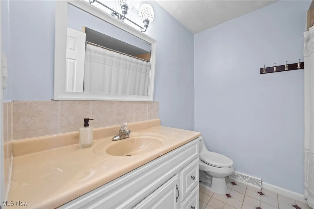 Bathroom with vanity and tile patterned floors