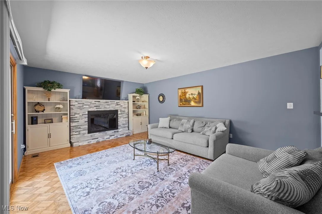 Living area featuring a fireplace and a textured ceiling