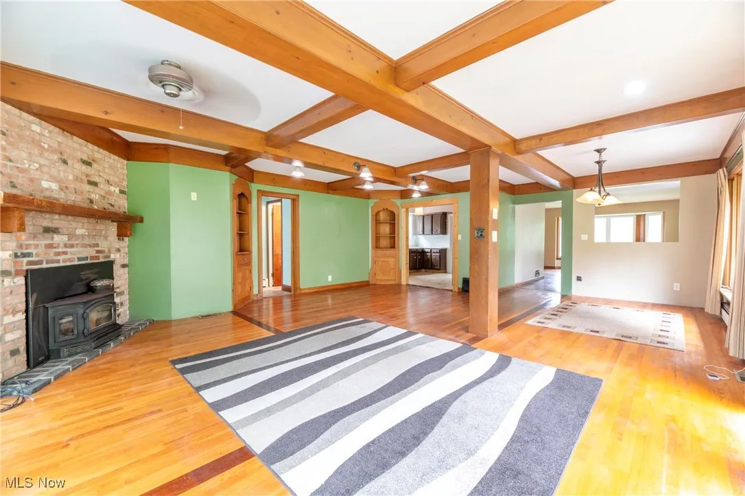 Family room with a fireplace and hardwood flooring