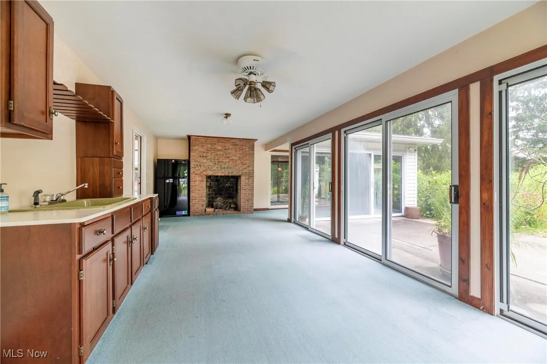 Covered patio with kitchen area and fireplace