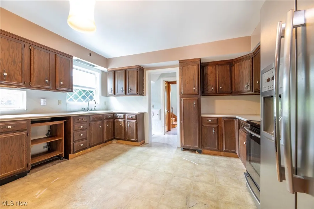 Kitchen featuring stainless steel appliances, light flooring, and light countertops