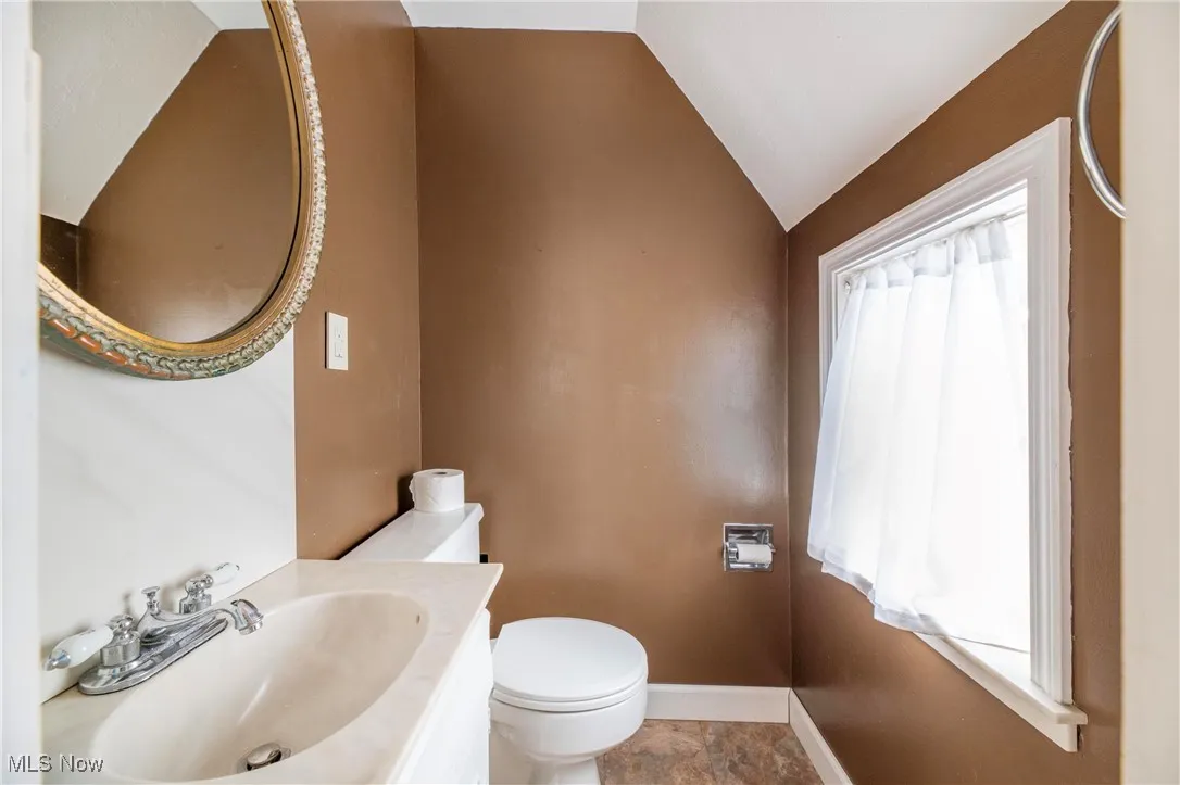 Bathroom featuring vanity and vaulted ceiling