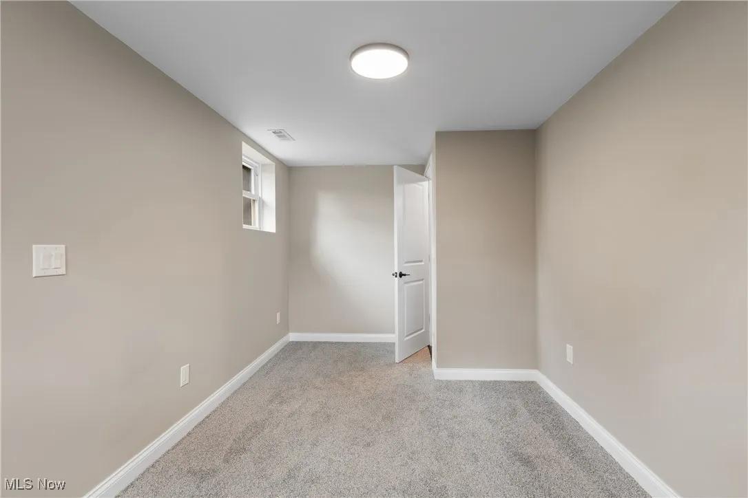 Basement featuring carpet floors and baseboards
