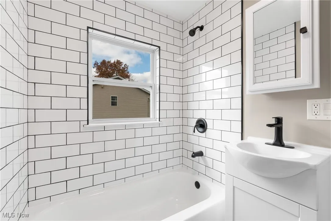 Full bath with shower / tub combination and vanity