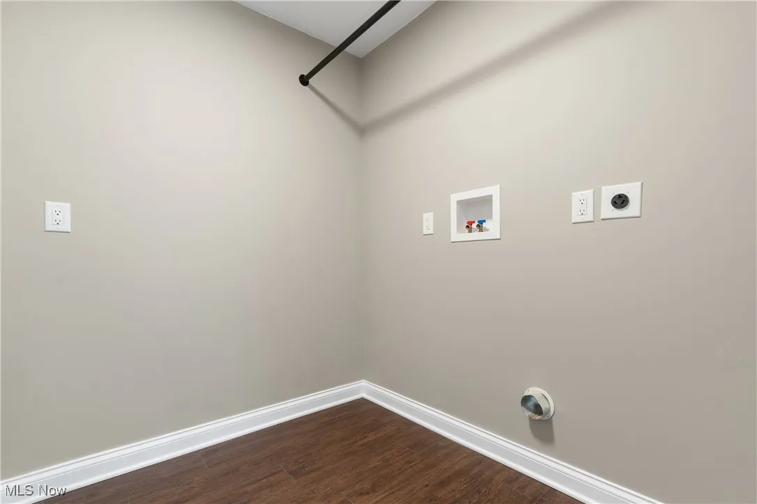 Laundry area with electric dryer hookup, washer hookup, and dark wood-style floors