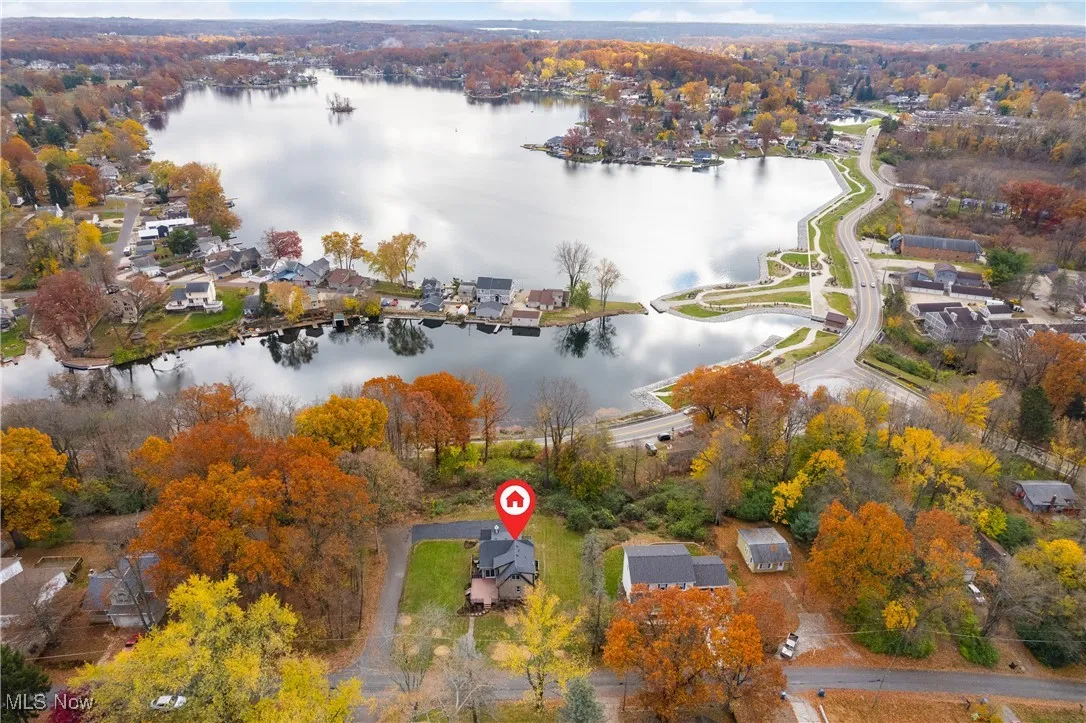 Aerial overview of property's location featuring a large body of water and nearby suburban area